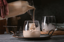 Irish cream coffee liqueur with ice on dark background