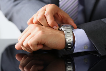 Man in suit and tie check out time at silver wristwatch closeup. Waste minute modern punctual life style start hurry job idea last second clockwork precision concept