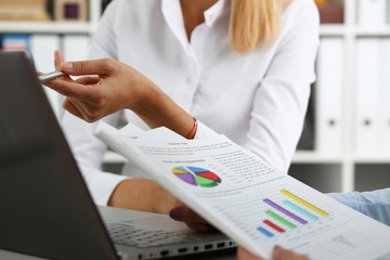 Group of people deliberate on problem with clipboard pad closeup. White collar check money papers stock exchange market earnings list partnership agreement discussion or dispute concept