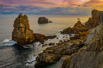 Wall Mural - Incredible cliffs on the coast near the village of Liencres before sunrise. Cantabria. Northern coast of Spain