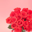 Bouquet of red roses on pink background