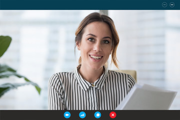 Headshot portrait screen view of young businesswoman consult client online using Webcam conference, smiling female employee speak talk on video call with partner or colleague from home office