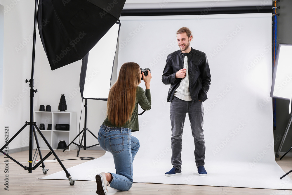 Professional photographer working with model in studio