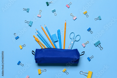 Cuadros en Lienzo Pencil case and school stationery on color background