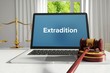 Extradition – Law, Judgment, Web. Laptop in the office with term on the screen. Hammer, Libra, Lawyer.