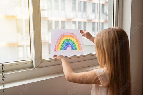 Cuadros en Lienzo Kid painting rainbow during Covid-19 quarantine at home