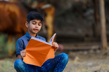 Wall Mural - Cute indian child studying at home