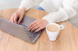 © Marharyta Manukha - Woman is typing on keyboard of laptop or notebook at home freelance, check electronic mail, get some information for shopping online or operate of banking on web. Cup of coffee.
