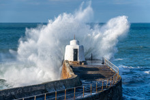 Close Up Of A Large Wave Pounding The Harbour Wall At Portreath, Cornwall