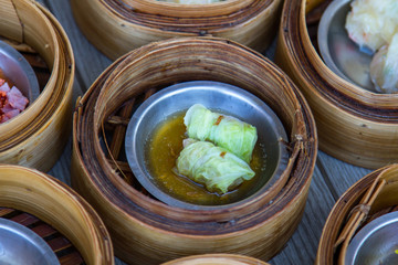 various dim sum in bamboo steamer in chinese restaurant