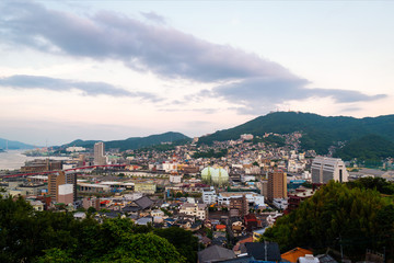 Poster - A sunrise view made from a hill in Nagasaki, Japan, with a view over the entire center