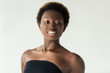 © LIGHTFIELD STUDIOS - smiling african american girl in black top isolated on grey