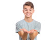 © valiza14 - Portrait of cute smiling teen boy holding nothing. Happy teenager with empty palms up, isolated over white background. Child stretched out his hands - sign of begging or giving.