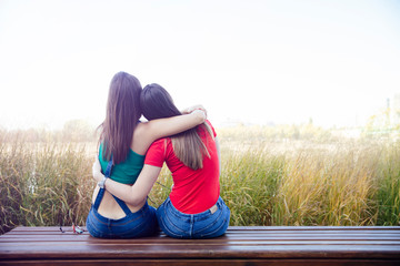 Wall Mural - Two best female friends embracing together