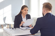 Woman employer talking interviews a man for a job vacancy in a company