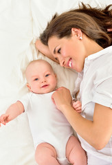 Wall Mural - Mother and baby playing and smiling. Happy family.