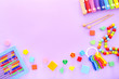 © Limages Studio - Colorful kids toys on purple background. Top view