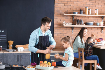 Sticker - Young family cooking together in kitchen