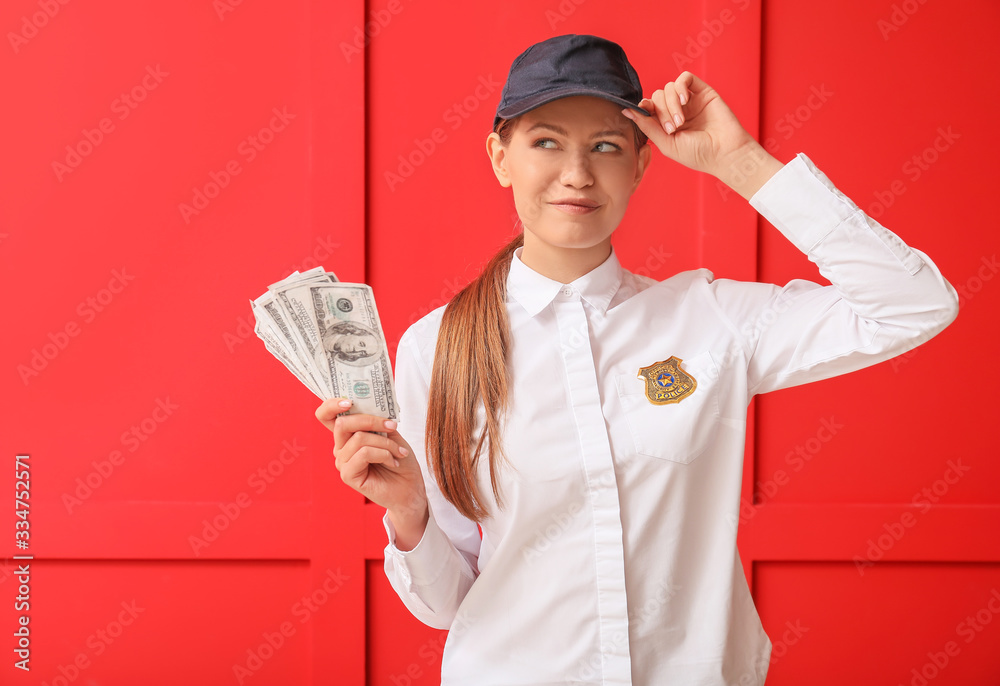 Beautiful young policewoman with money on color background