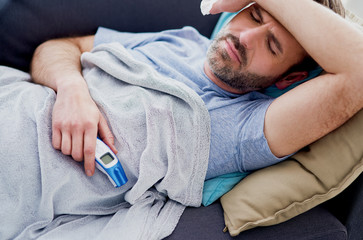 Man with high temperature staying at home