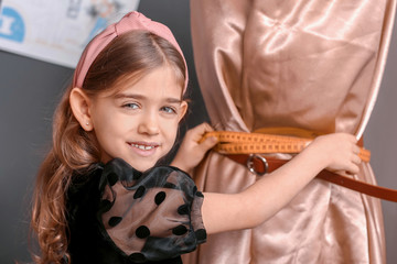 Canvas Print - Cute little dressmaker working in atelier