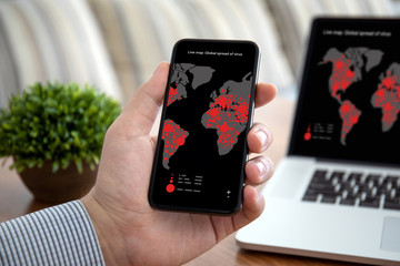 male hand holding phone live map global spread of virus