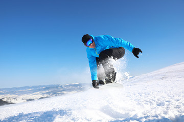 Sticker - Man snowboarding on snowy hill. Winter vacation