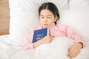 Canvas Print - Cute little Asian girl with Bible sleeping in bed