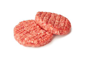 Two raw burger patties on white