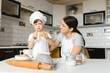 © Serhii - Happy family. Mother teaching her son how to cooking cake menu in morning. healthy lifestyle concept.. Baking Christmas cake and cook concept