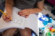 © Rachel Weill - Close-up of young child's hands practicing writing in a school notebook