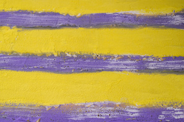 Abstract plaster texture in light shades of yellow and purple.