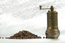 Black Pepper And Vintage Mill On Silver Background. Spice Grinder And Heap Of Grains Of Pepper. Sample For Packing