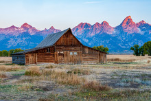 Historic Mormon Barn In Front Of The Grand Tetons At Sunrise, Grand Teton National Park, Wyoming.
