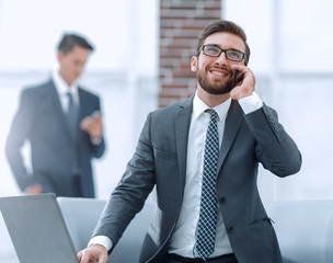 Wall Mural - Confident young man talking on phone in office