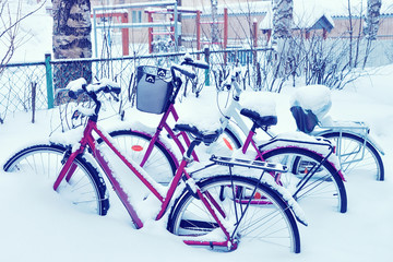 Wall Mural - Bicycles covered by snow and parked in street winter Rovaniemi