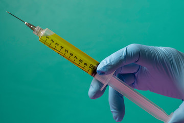 healthcare professional holding a syringe ready to give the injection