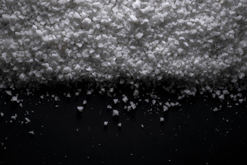  sea salt black Background of grains of salt crystals production. Heap of coarse salt