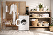 © New Africa - Modern washing machine and shelving unit in laundry room interior
