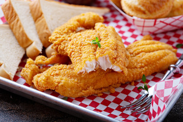 Wall Mural - Fried catfish with cornbread dipped with buttermilk and seasoned with cornmeal, southern tradition