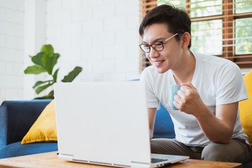 Work from home or work at home concept, asian man working with laptop computer due to quarantine from coronavirus covid-19