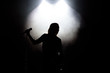 © nagaets - black silhouette of female singer with white spotlights in the background
