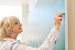 © Robert Kneschke - Woman as lecturer writes on blackboard