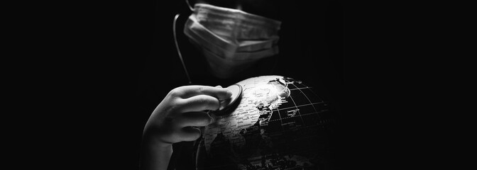 Wall Mural - kid hold globe put stethoscope on sphere, face covered in mask on black horizontal background. ecolo