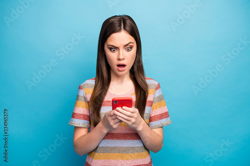 Close-up portrait of her she nice lovely worried mad irritated girl using device browsing smm feedback media isolated over bright vivid shine vibrant blue color background