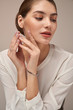 © serhiibobyk - Model demonstrating bracelet, isolated on gray.