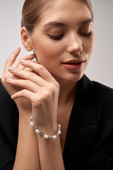 Young brunette model demonstrating jewelry.