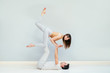 © Iryna - Loving young couple having acro yoga practice in bed at home, sporty strong shirtless man holding slender attractive woman, happy smiling girlfriend doing sport exercise with boyfriend, trust concept