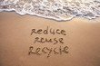 © Song_about_summer - reduce reuse recycle concept drawn on sand, sustainability