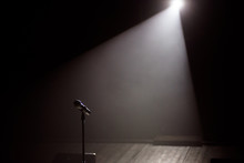 Close Up Of Microphone On Stage In Black Background.
